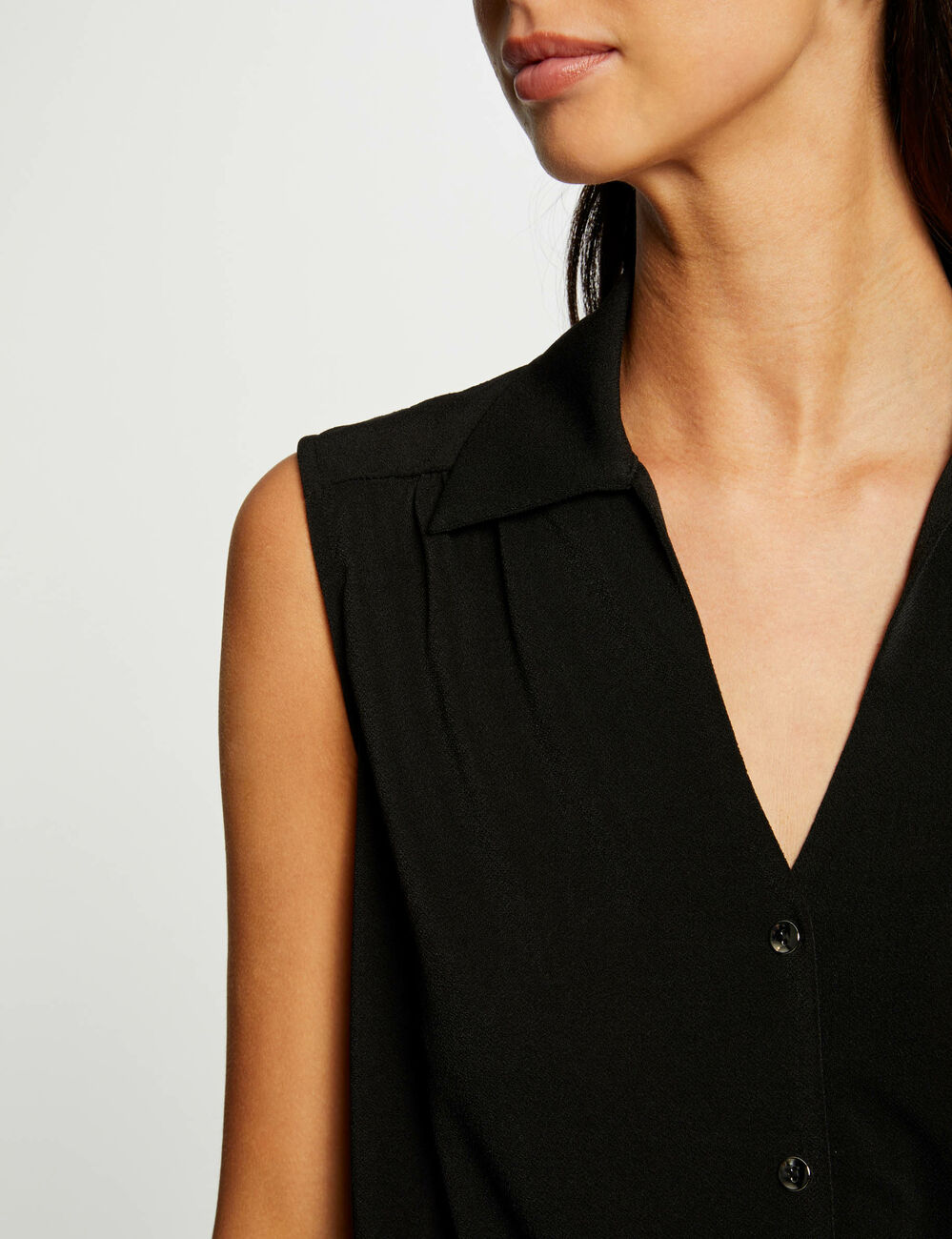 Blusa anudada sin mangas negro mujer